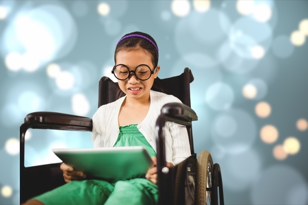 Digital composite of Girl in wheelchair using digital tabletの写真素材