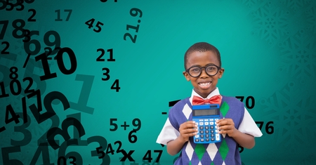 Digital composite of Happy school boy holding calculator against flying numbersの写真素材