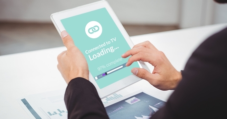 Digital composite of Cropped image of businessman using digital tablet with loading screen