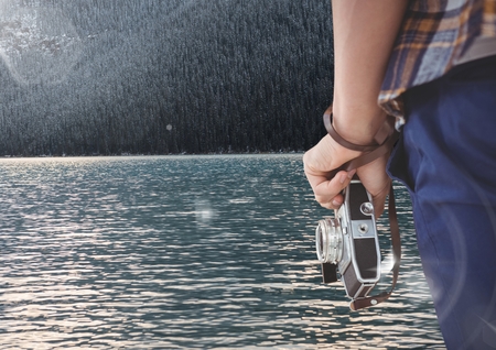 Digital composite of travel mountain. lake traveler hand with cameraの写真素材