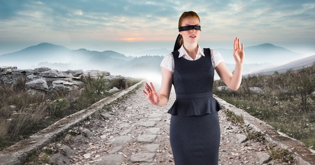 Digital composite of Business woman blindfolded walking down roadの写真素材