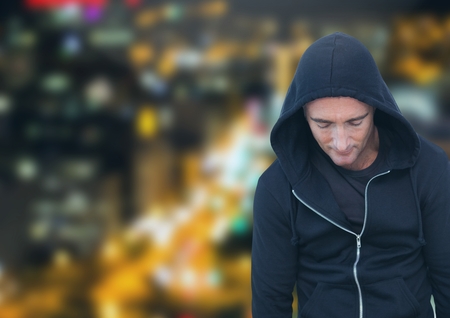 Digital composite of Criminal in hood in front of night cityの写真素材