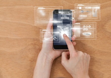 Digital composite of Overhead of hands with phone and white interface with flare
