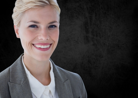 Digital composite of Business woman smiling against black wallの写真素材