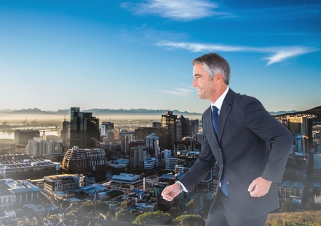 Digital composite of Walking businessman over cityの写真素材