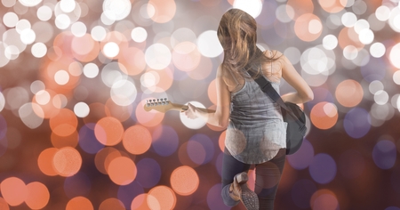 Digital composite of Rear view of music artist playing guitar over bokehの写真素材