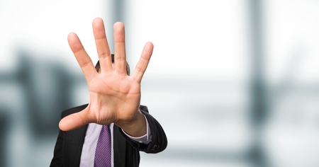Digital composite of Displeased businessman showing stop sign