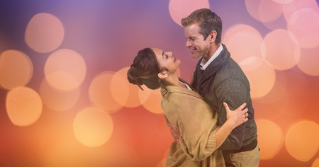 Digital composite of Loving couple embracing over blur backgroundの写真素材