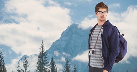 Digital composite of Handsome man traveling on mountainsの写真素材