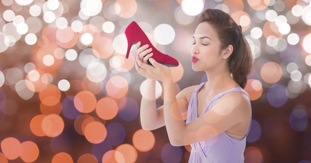 Digital composite of Young woman kissing new footwear over bokehの写真素材