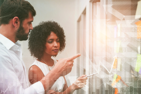 Stocks and shares against business team planning with sticky notesの写真素材