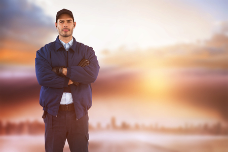 Security standing with arms crossed against cityscape on the horizonの写真素材