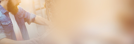 Side view of hipster repairing bicycle at workshopの写真素材