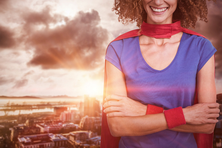 Portrait of a woman pretending to be superhero against cityの写真素材