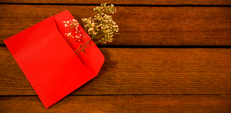 High angle view of white flower in envelope on wooden plankの写真素材