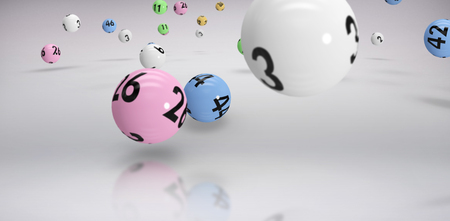 Falling lottery balls  against grey background