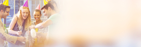 Creative business people celebrating birthday in creative officeの写真素材