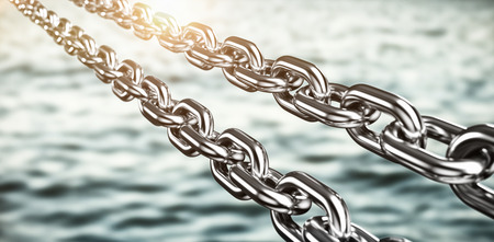 Digitally generated image of 3d silver metallic chains against beautiful day in the waterの写真素材