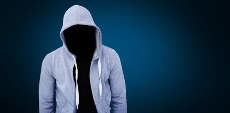 Robber wearing gray hoodie against blue background with vignetteの写真素材