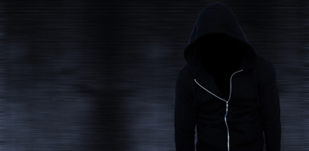 Hiker wearing black hoodie against black backgroundの写真素材