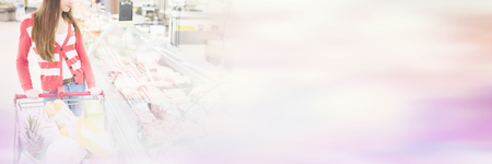 Woman is looking meat at supermarketの写真素材