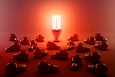 Digital composite image of illuminated energy efficient lightbulb by bulbs on gray backgroundの写真素材