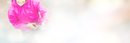 Portrait of woman abseiling down from rock face on mountainの写真素材