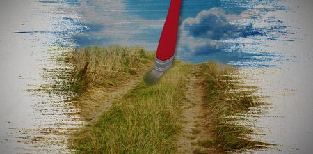 Digital composite image of red paintbrush against blue sky over sand dunesの写真素材