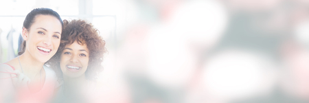 Portrait of smiling friends holding shopping bags at shopの写真素材