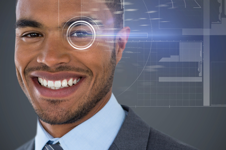 Portrait of smiling businessman  against dark grey backgroundの写真素材