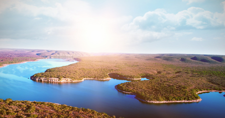 Scenic view of river and field against clear skyの写真素材