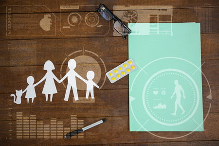 Human body organ development illustration against black background against paper cut out family chain with medicine and file on tableの写真素材