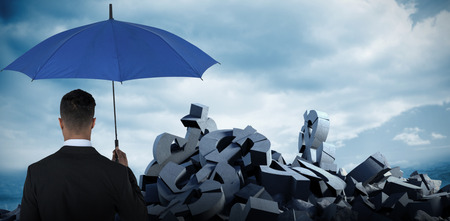 Rear view of businessman carrying blue umbrella  against full frame shot of skyの写真素材