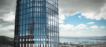 3d image of modern building  against landscape of city and cloudy sky