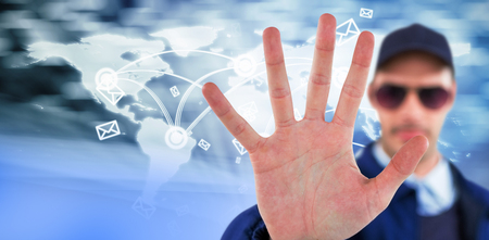 Confident security officer making stop gesture against virus backgroundの写真素材