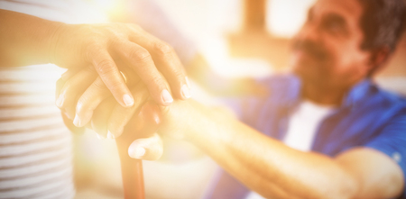 Close-up of senior couple holding walking stickの写真素材