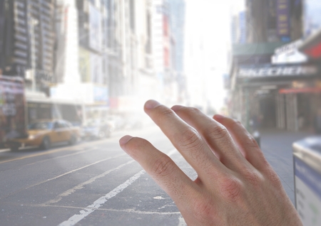 Digital composite of Hand touching flare on city streetの写真素材
