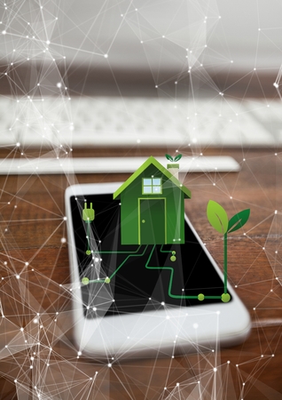 Digital composite of renewable energy house on phoneの写真素材