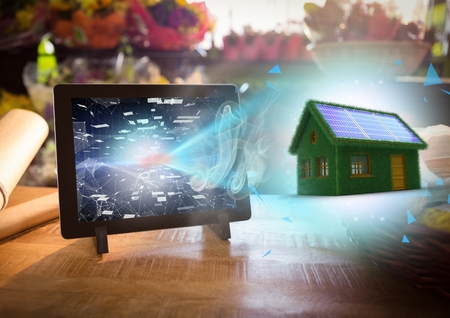 Digital composite of grass house going out from the tabletの写真素材