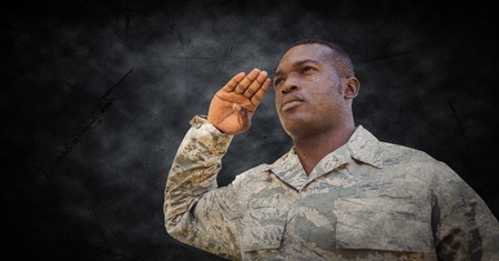 Digital composite of Soldier saluting with black grunge background and overlayの写真素材