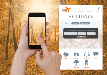 Digital composite of Hand Touching phone and Holiday break App Interface in forestの写真素材