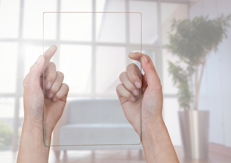 Digital composite of Hands holding glass screen against window