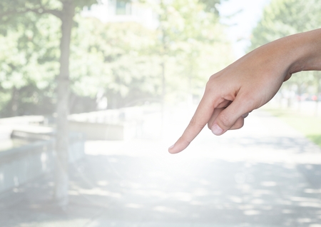 Digital composite of Hand pointing in  air of parkの写真素材