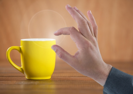 Digital composite of Hand Touching  air with cupの写真素材