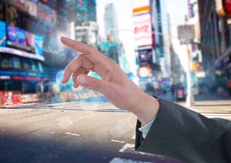 Digital composite of Hand Touching  air of city streetの写真素材