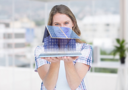 Digital composite of bateery house on tablet. Businesswoman in the officeの写真素材