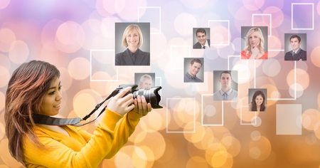 Digital composite of Female photographer using SLR camera by flying portraitsの写真素材