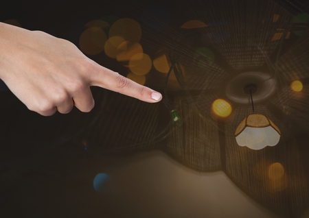 Digital composite of Hand touching  air with various lightsの写真素材