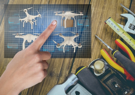 Digital composite of Hand pointing at a Drone DIY building App Interface