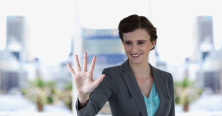 Digital composite of Happy businesswoman gesturing outdoorsの写真素材